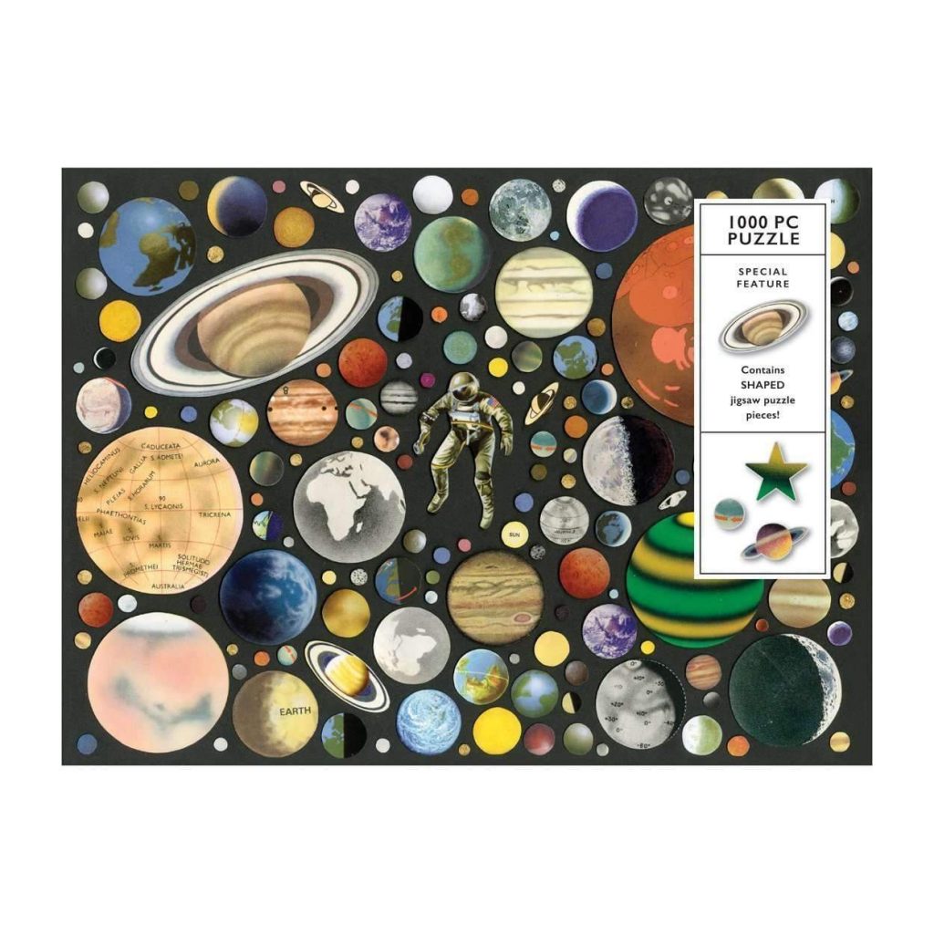 Zero Gravity 1000 Piece Puzzle features the planets of the universe hand-cut in a cosmic collage of color. This unique puzzle includes 20 puzzle pieces that are die-cut in the shape of the planet! Galison puzzles are packaged in matte-finish sturdy boxes, perfect for gifting, reuse, and storage. - 1000 Piece Puzzle with Shaped Puzzle Pieces - 2 Piece Wrapped Box - Includes 20 Shaped Puzzle Pieces - Puzzle Size: 27 x 20", 686 x 508 mm - Box Size: 11.5 x 8.5 x 2", 292 x 216 x 51 mm